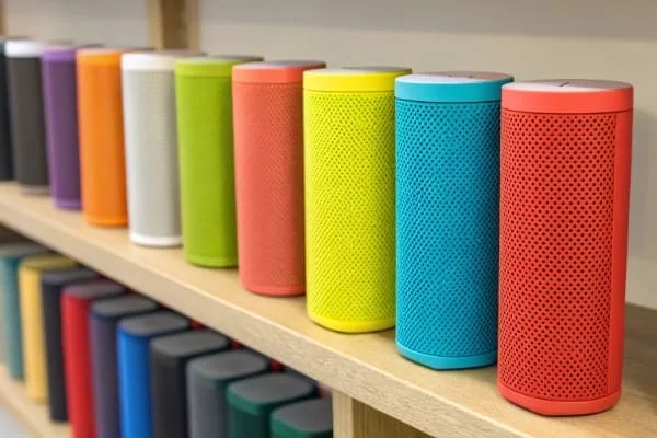 A collection of colorful Bluetooth speakers on a shelf