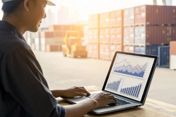 A person confidently managing their supply chain on a laptop
