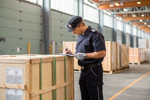 A customs officer inspecting a shipment in Germany