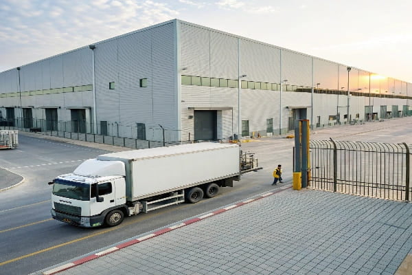 A delivery truck arriving at a warehouse in Qatar