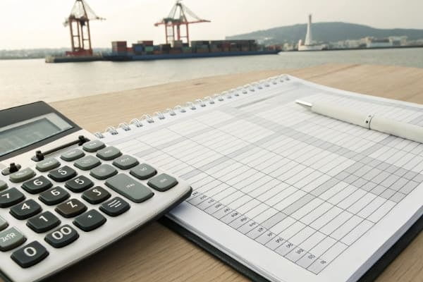 Calculator and customs form to illustrate import duty and GST calculation