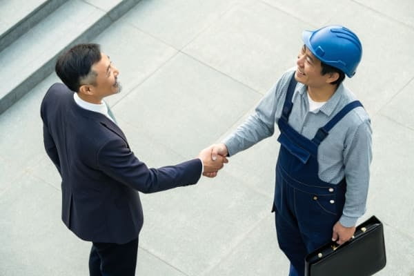 A handshake sealing a partnership deal between a business owner and a China sourcing agent