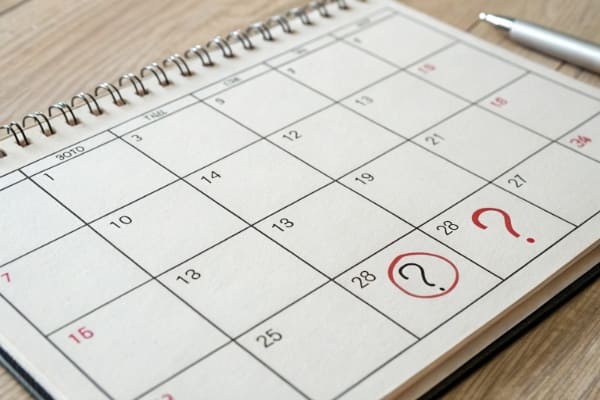 A calendar with question marks indicating uncertainty