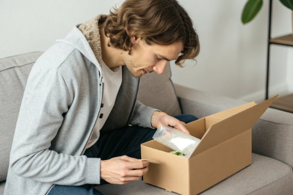 A person unboxing a product sample sent from a manufacturer