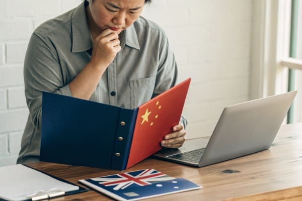 A person deciding between a China-based and Australia-based company