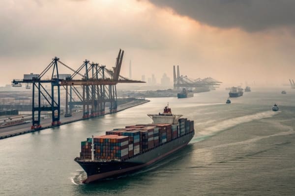 A large container ship sailing towards Jebel Ali port in Dubai