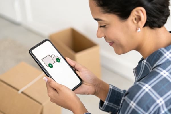 A person checking shipment status on their phone