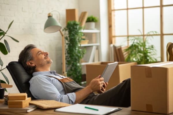 A business owner relaxing while their shipment is in transit