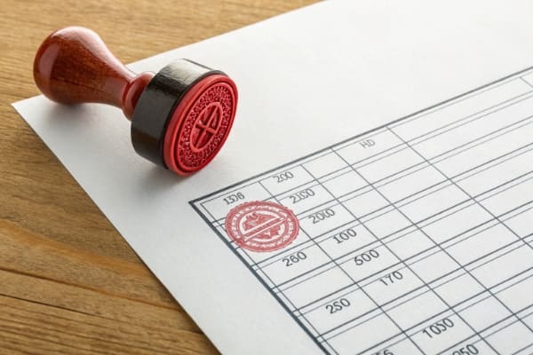 An invoice with red stamps showing unexpected fees and charges